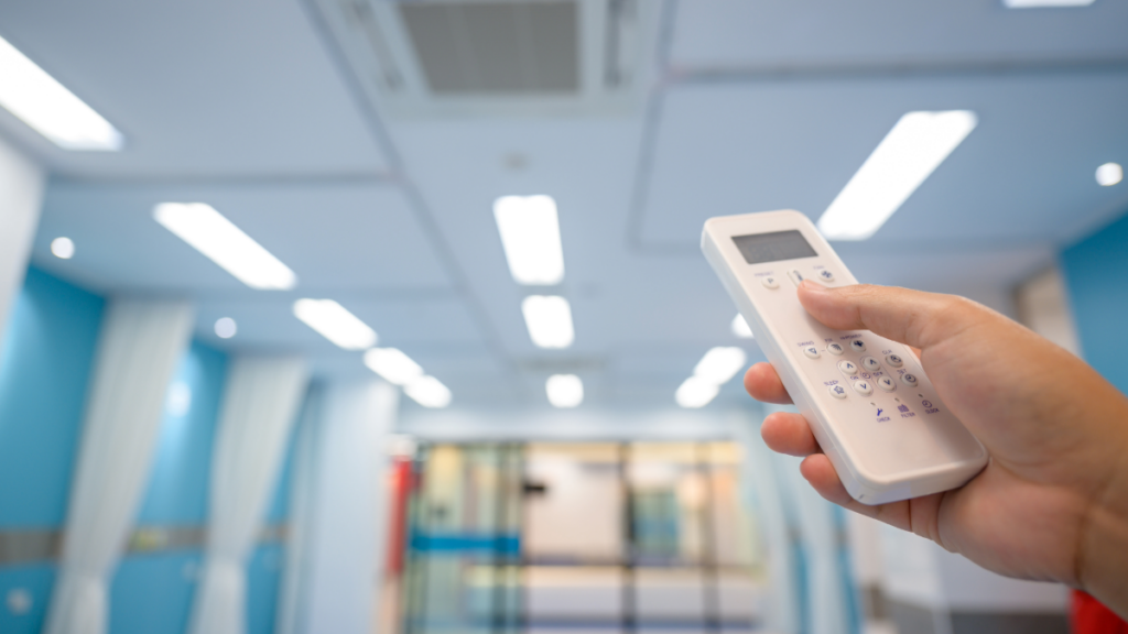a healthcare worker using a smart remote to control the hvac system