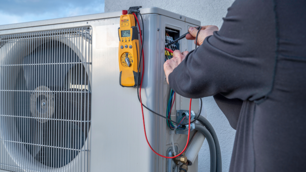 a technician installing a ductless mini split ac unit 1024x576 1