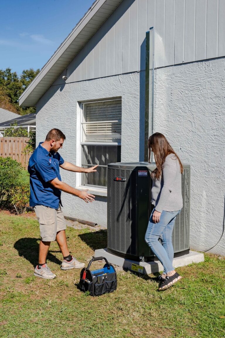 An AC technician explains the HVAC tune up process to a VIP HVAC Maintenance member